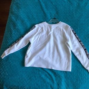 White sweatshirt, effortless written on sleeve